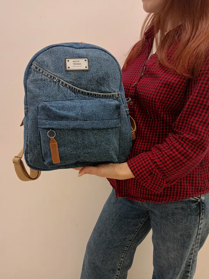Everyday denim backpack made from recycled jeans, 3 pockets outside (1 volumetric with a zipper), 2 pockets inside (1 with a zipper) 100 percent cotton inside, strong handles made of cotton straps, leather strips on the zipper puller. decorated with a lab