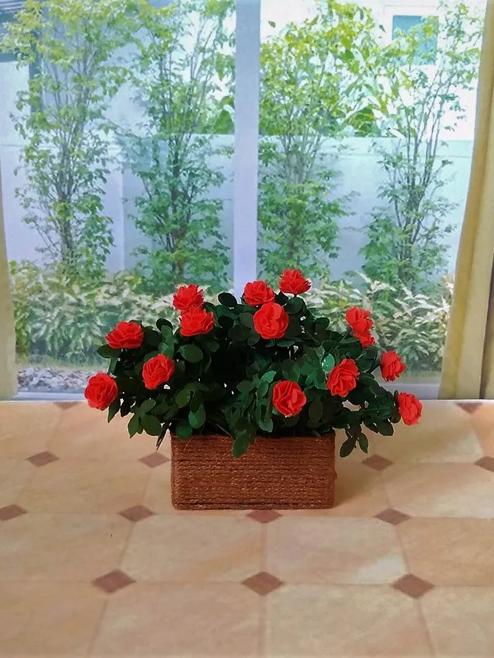 Miniature roses in a flowerpot. Dollhouse miniature.