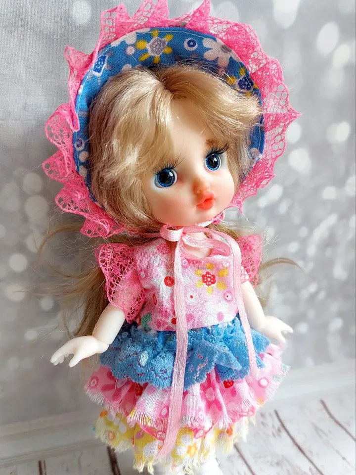 Blonde doll with blue eyes. Small doll on an articulated body.