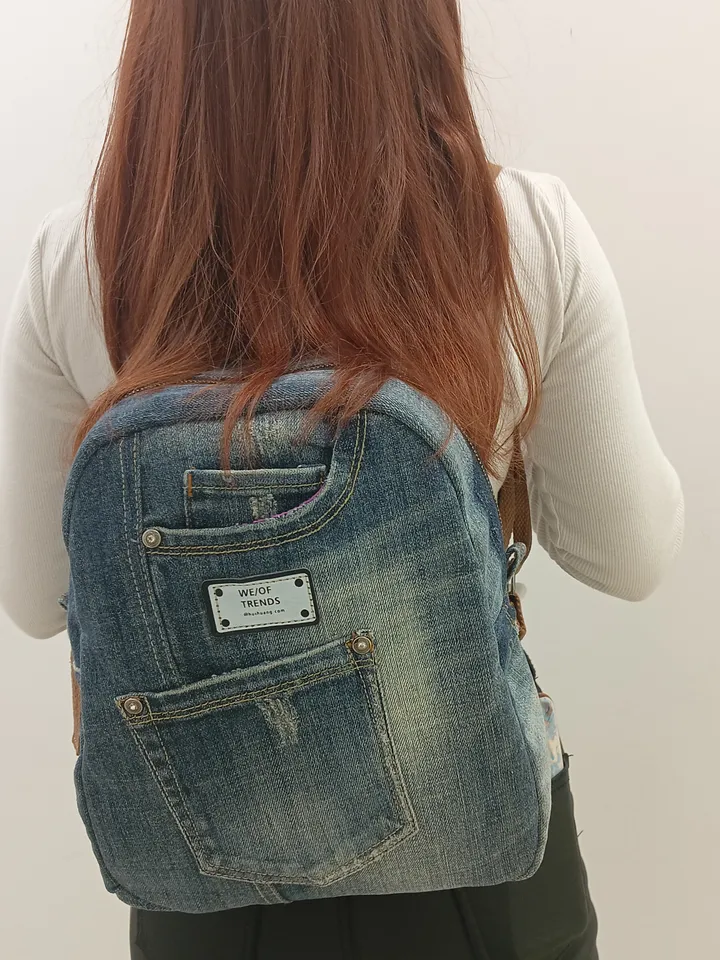 Denim backpack with 100 percent cotton lining, handmade, recycled jeans, 5 pockets on the outside, 2 deep pockets on the inside, strong webbing straps, decorated with a label and genuine leather on the zipper puller. size: height 30 cm. *25*12cm