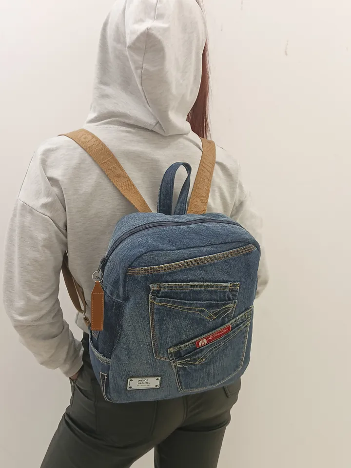 Casual unisex denim backpack made from eco-frendly recycled jeans, with 6 pockets outside and 2 pockets inside (1 with a zipper), strong belt on adjustable straps. Inside is colored cotton fabric. The back wall is quilted.
