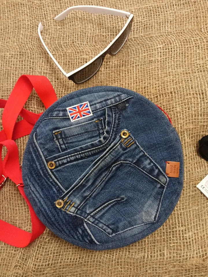 Cute round denim handbag with 5 pockets, adjustable strap and polka dot cotton inside.