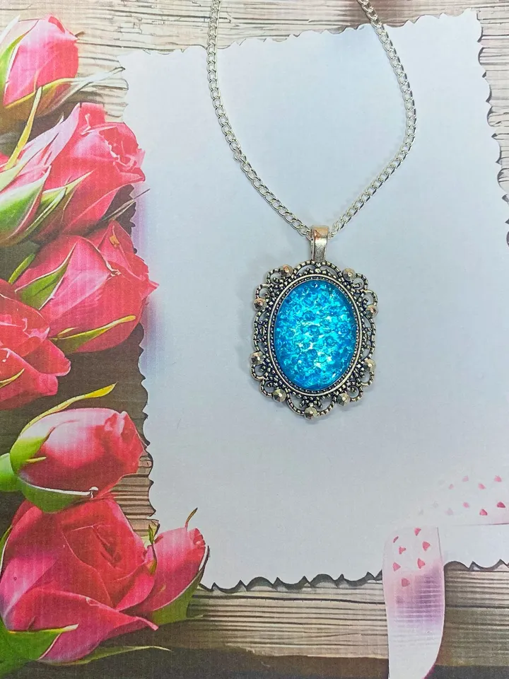 Bright, turquoise pendant on a handmade cord. Handmade jewelry with turquoise rhinestones.
