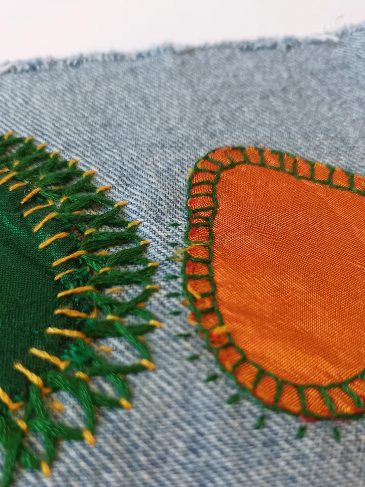 Upcycled denim boro patch – visible mending.