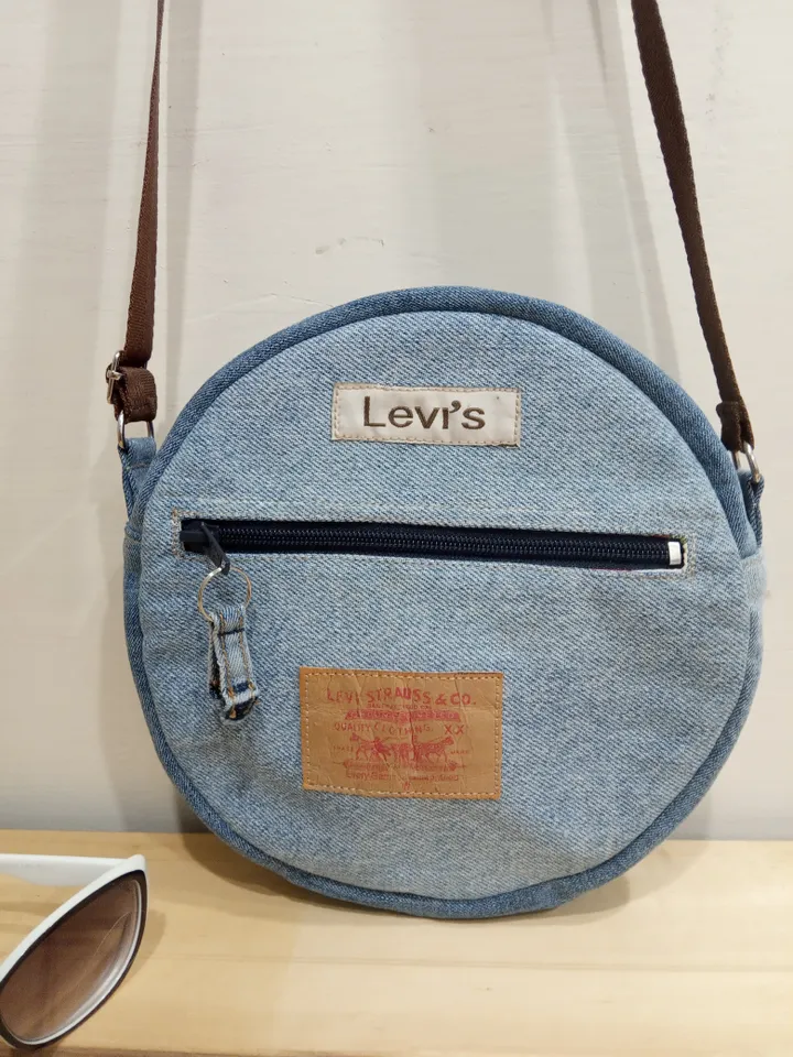 Round denim crossbody bag with a long strap