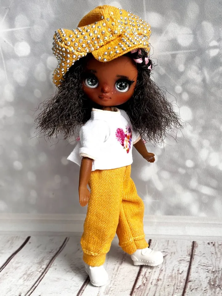 Petite Blythe with dark skin. Adorable miniature doll on an articulated body.