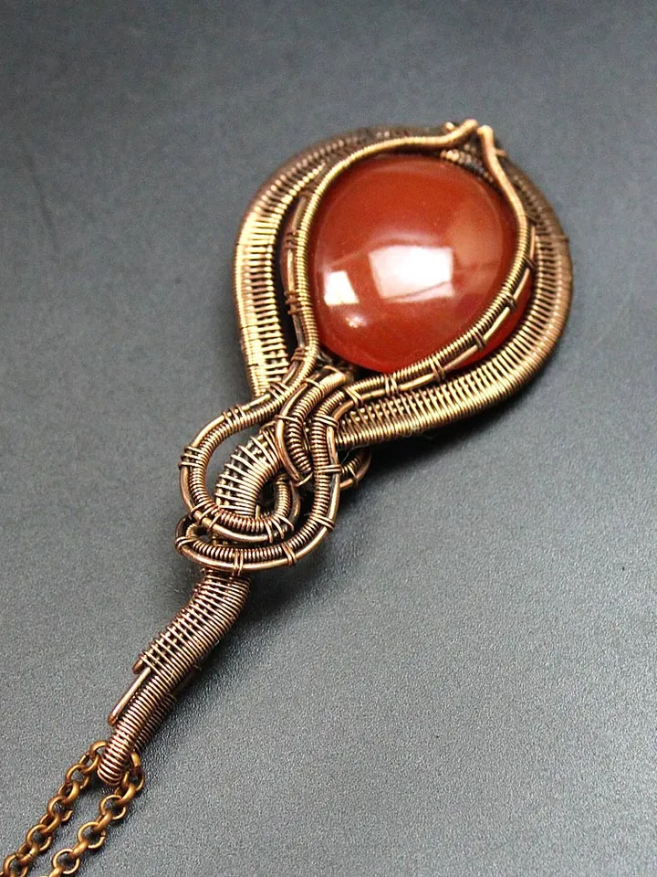 Handmade Pendant made of copper wire and natural carnelian stone