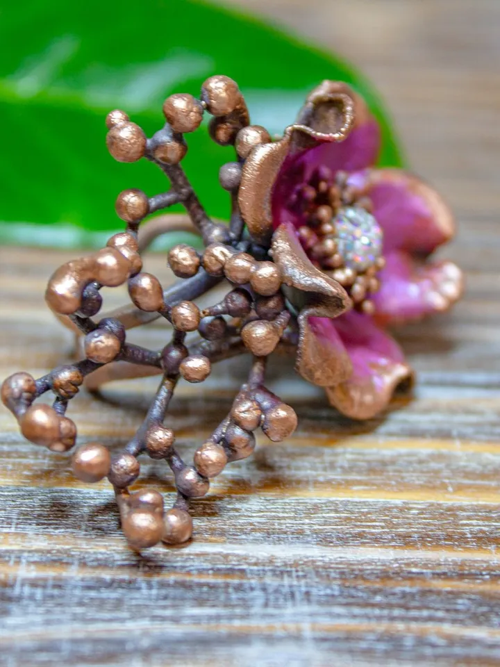 Unique handmade copper ring made from a real flower bud using the electroforming method, decorated with a Swarovski crystal