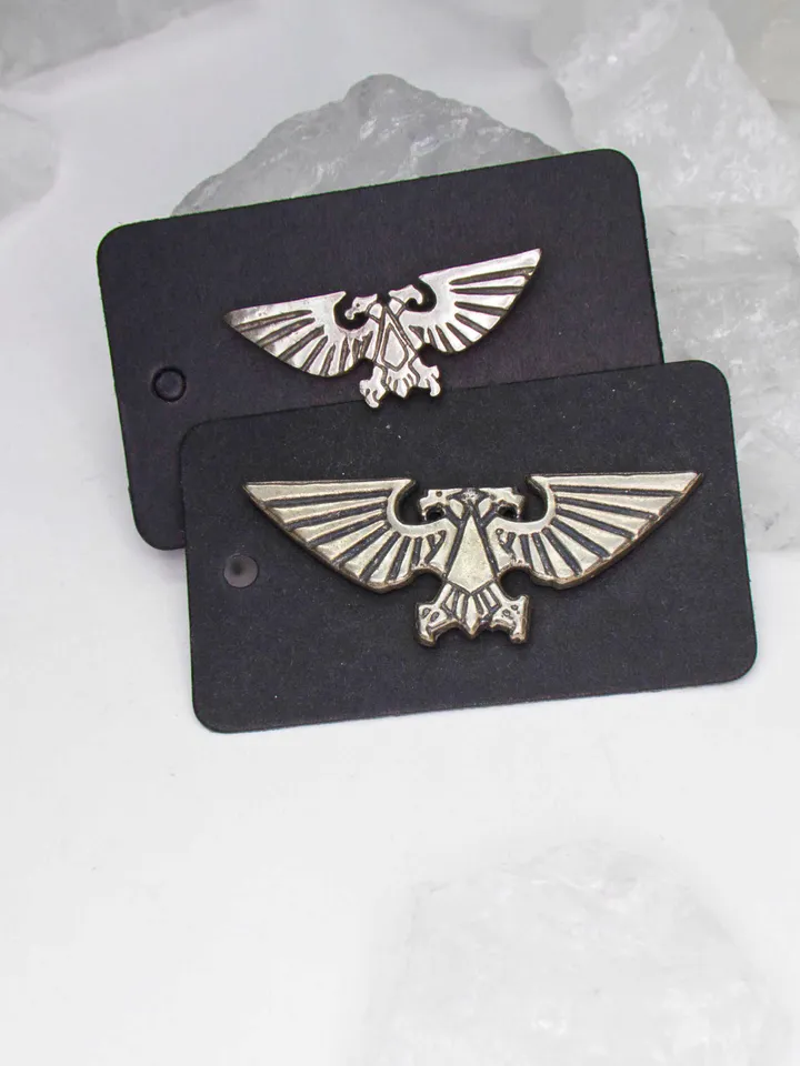 A pair of Large and Medium Imperial Aquila badges (German Silver CuNiZn)