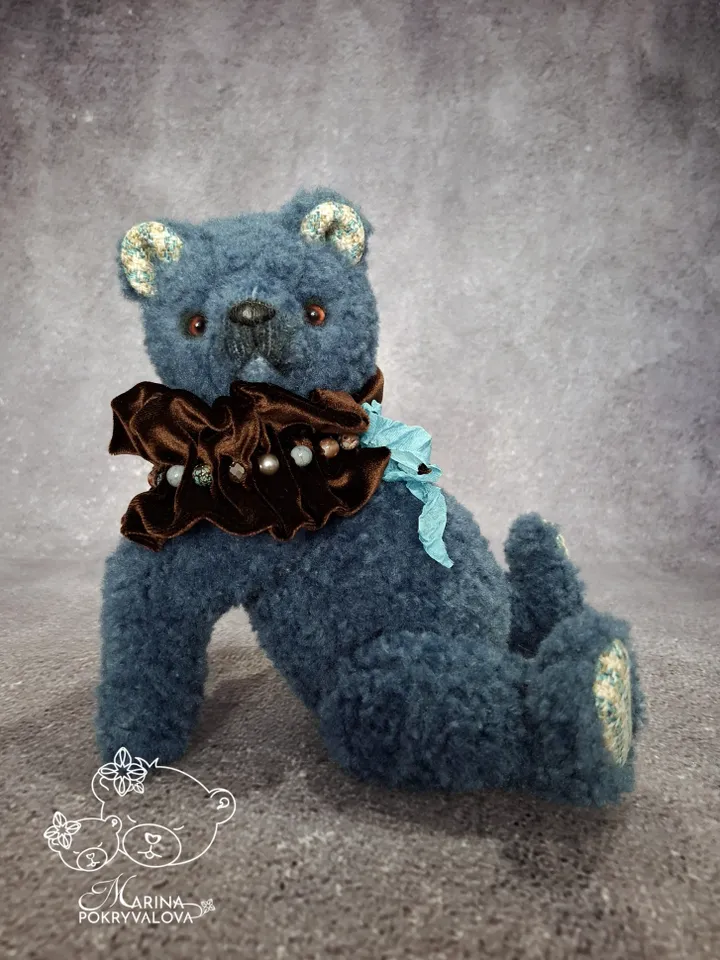 Blue teddy bear. Handmade toy. Plush bear.