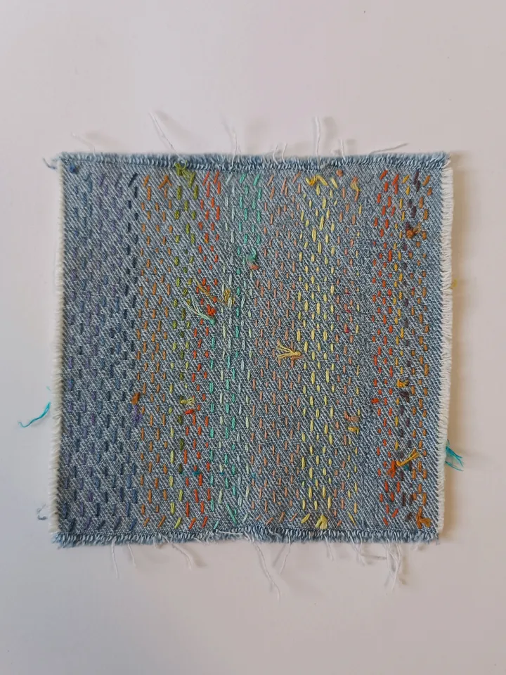 Upcycled denim boro patch – visible mending.