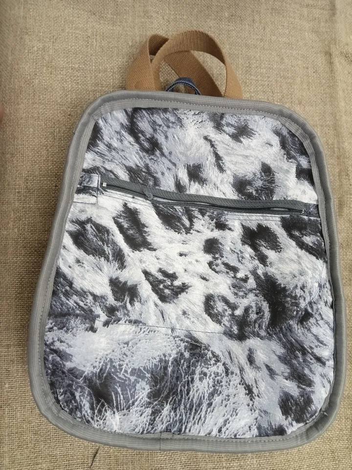 Casual unisex denim backpack made from eco-frendly recycled jeans, with 6 pockets outside and 2 pockets inside (1 with a zipper), strong belt on adjustable straps. Inside is colored cotton fabric. The back wall is quilted.