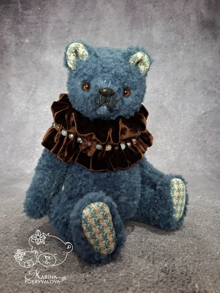 Blue teddy bear. Handmade toy. Plush bear.