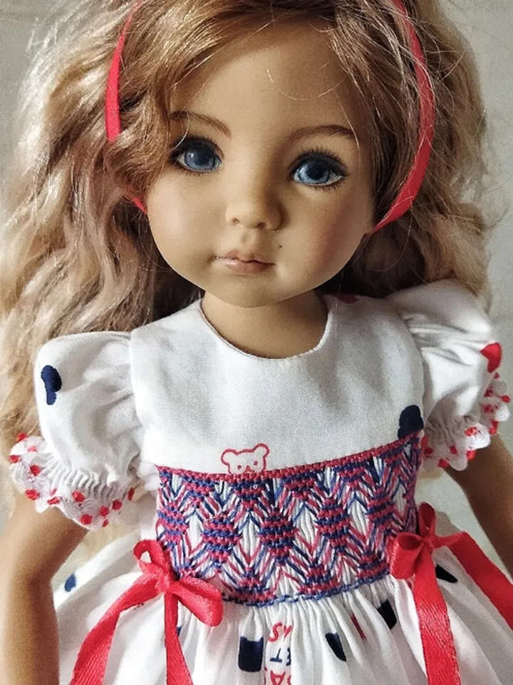Smocked dress with hand embroidery.