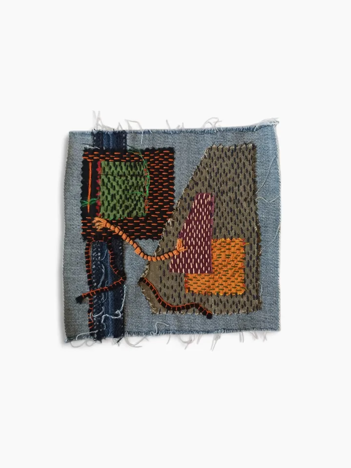 Upcycled denim boro patch with sashiko stitching – visible mending.
