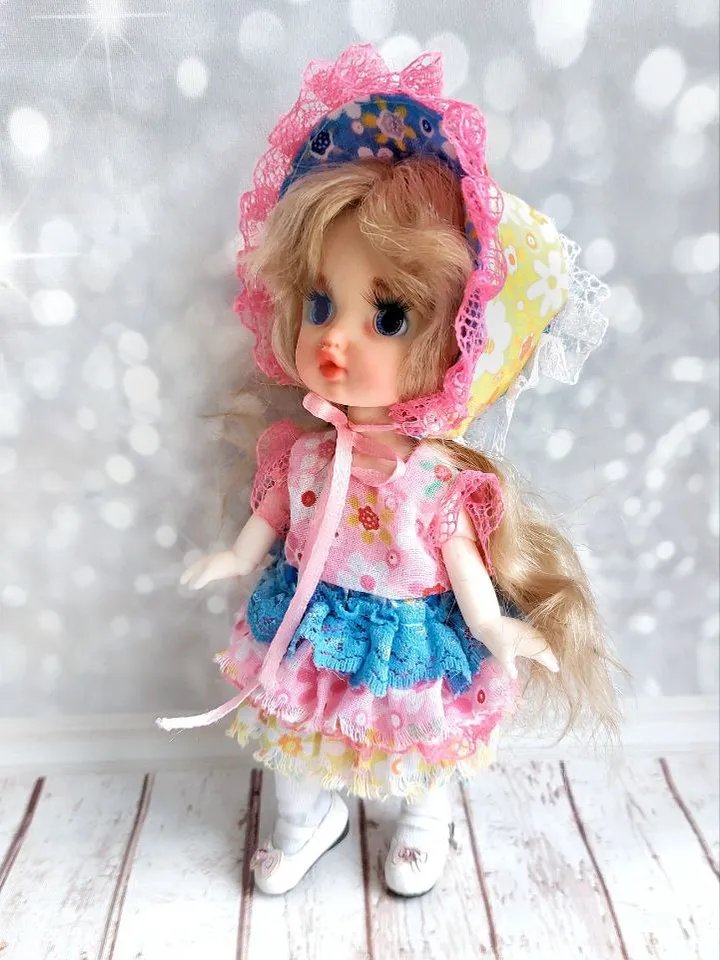 Blonde doll with blue eyes. Small doll on an articulated body.