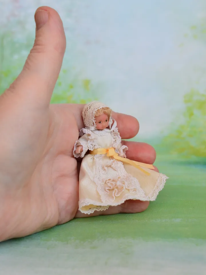 Miniature baby doll for Victorian dollhouse in 1/12 scale.