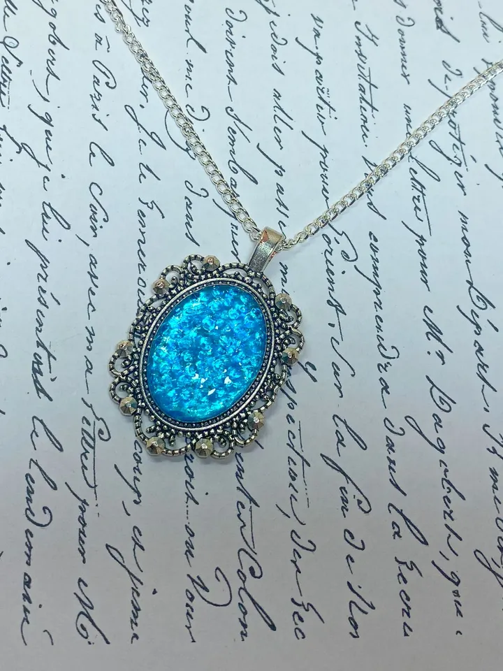Bright, turquoise pendant on a handmade cord. Handmade jewelry with turquoise rhinestones.