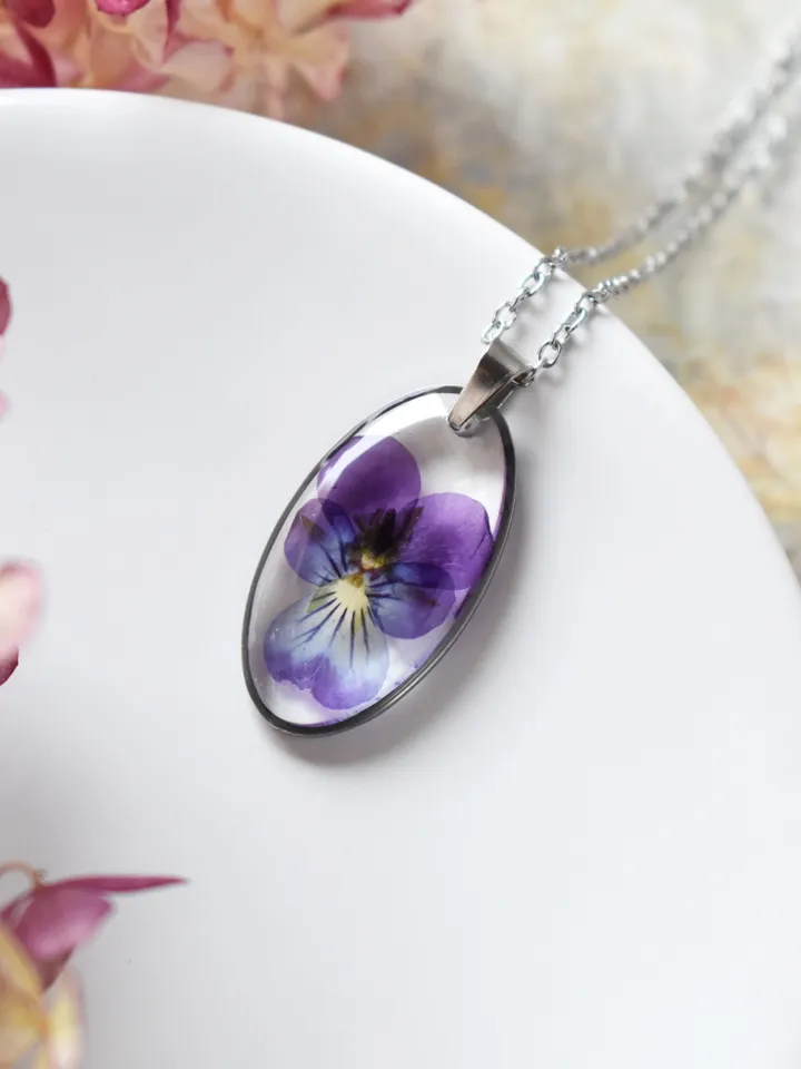 Pendant with a real pansy flower in the resin. Tiny viola flower necklace.