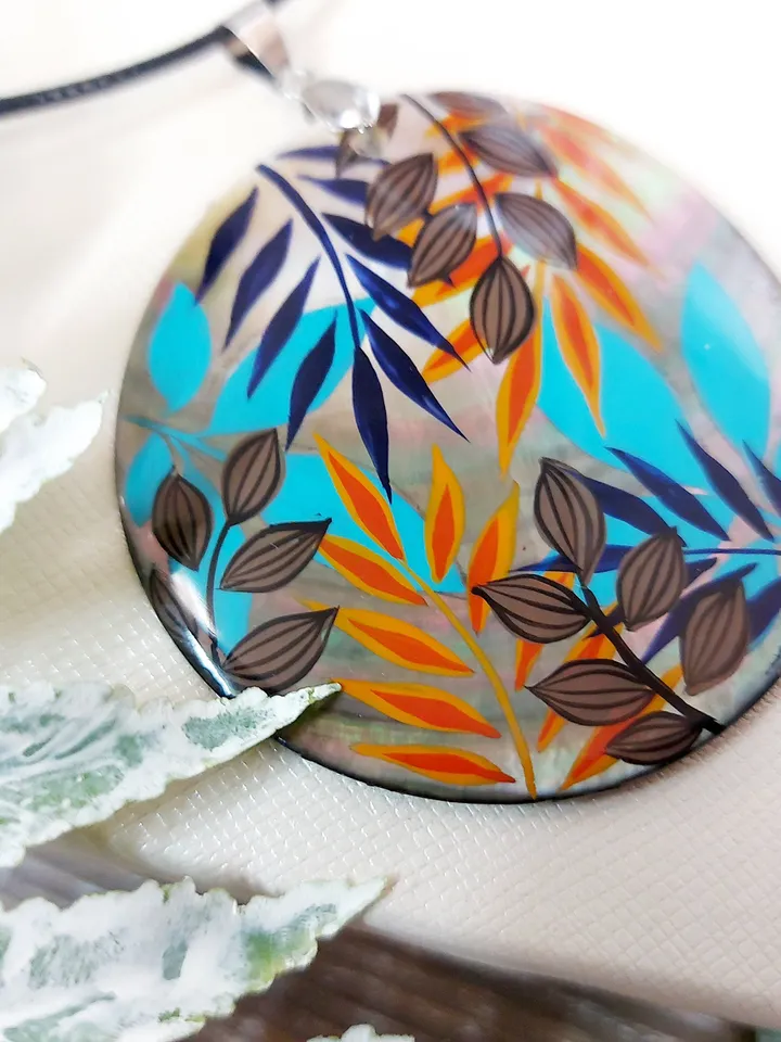 Artistic Expression in Nacre: Abstract Botanical Hand-Painted Mother-of-Pearl Pendant - Captivating Blue and Orange Leaf Motif