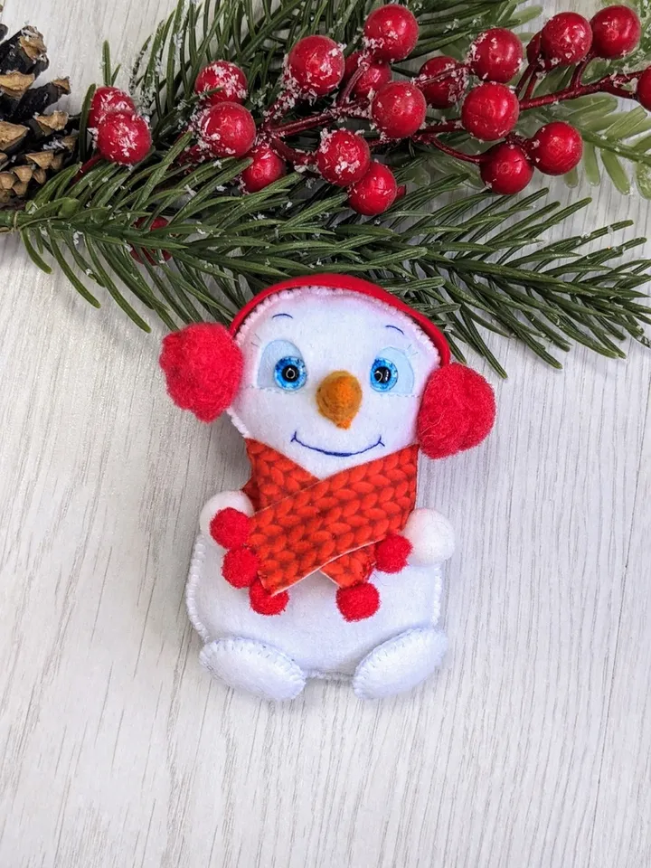Cute felt snowman. Snowman with blue eyes and red scarf
