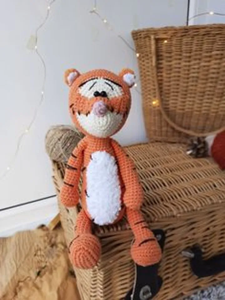 Orange tiger cub Disney cartoon character. Stuffed animal tiger soft toy