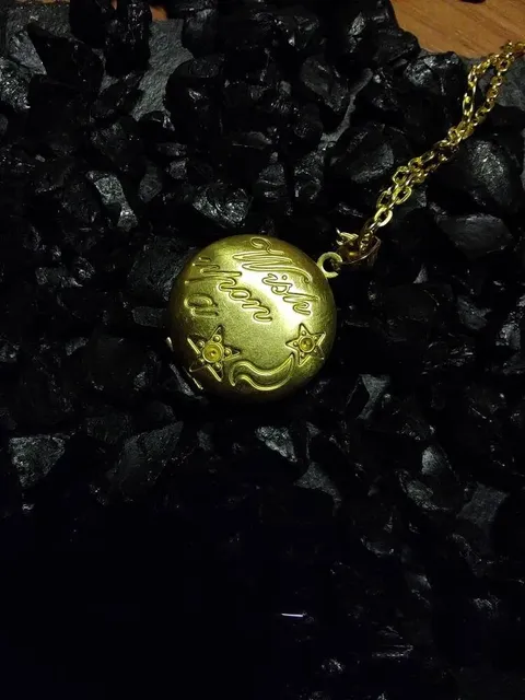 Round golden lockets with one of our solid perfumes inside