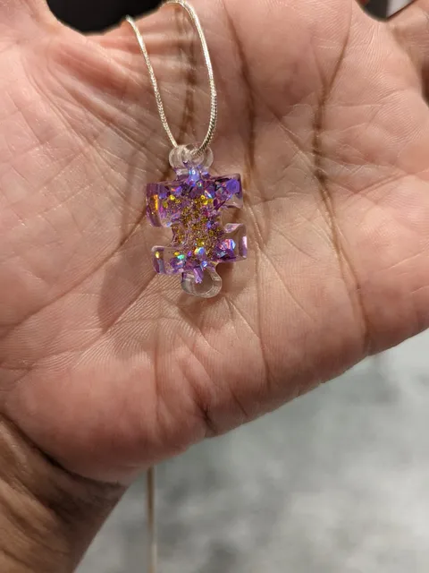 Resin puzzle piece necklace with purple and gold sparkles £6.50