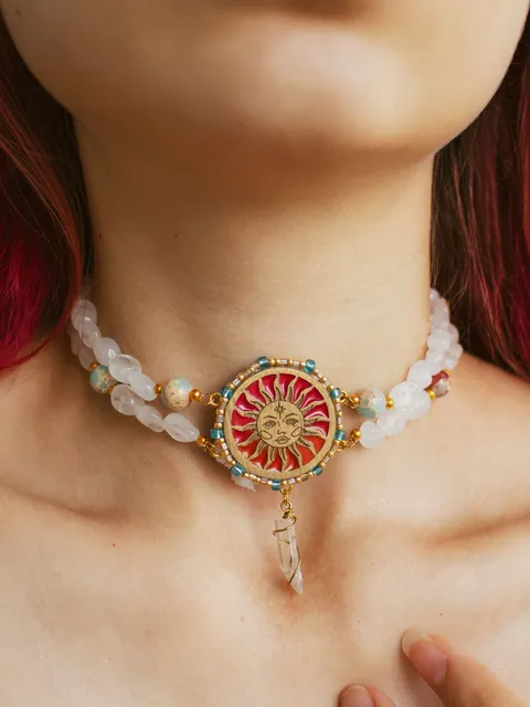 Choker necklace When The Sun Meets The Moon with blue jasper and clear quartz crystals. Gold jewelry with celestial design in sunset red and orange color with beading. Maylina Soul