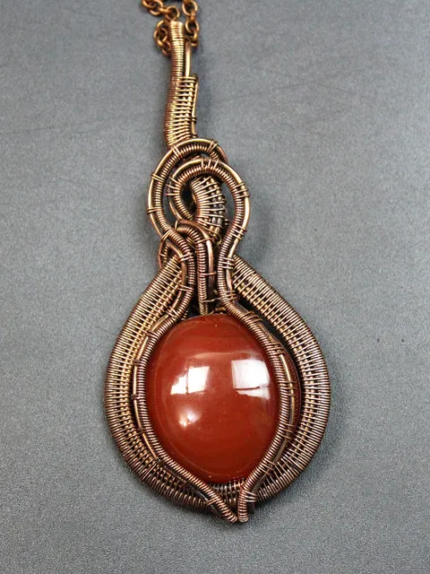 Handmade Pendant made of copper wire and natural carnelian stone