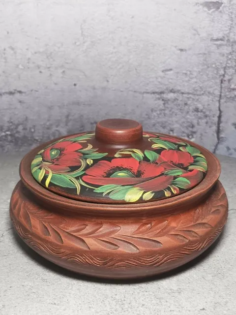 Ceramic casserole with a lid. Handmade from red clay. Carved pattern