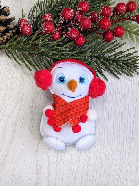 Cute felt snowman. Snowman with blue eyes and red scarf