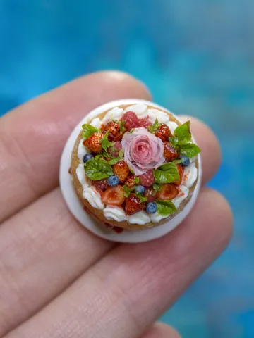 MINIATURE cake with rose and berries on a ceramic plate  1 $63.00