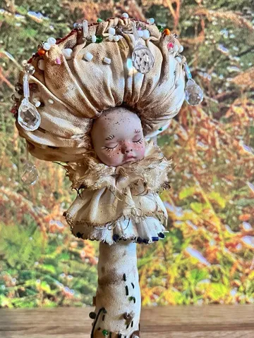 Art doll Mushroom. Unusual handmade figurine. Sleeping child-toy in the image of a fly mushroom. Unique statuette is made of fabric and polymer clay, decorated with beads and beads. An art object for your interior and collection