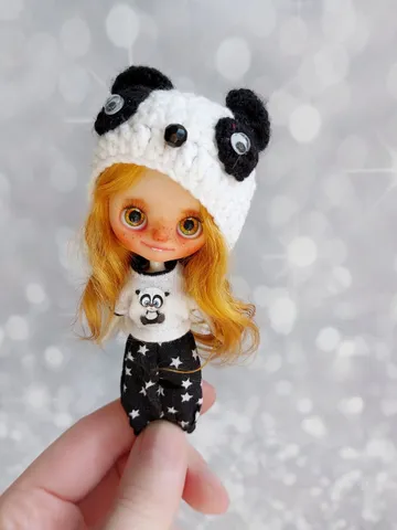 Funny little Petite Blythe doll with red hair. The doll is wearing a panda costume. $210.00