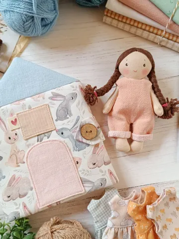Small portable textile dollhouse with doll and set of clothes $112.00