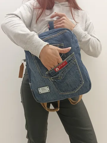 Casual unisex denim backpack made from eco-frendly recycled jeans, with 6 pockets outside and 2 pockets inside (1 with a zipper), strong belt on adjustable straps. Inside is colored cotton fabric. The back wall is quilted. $83.00