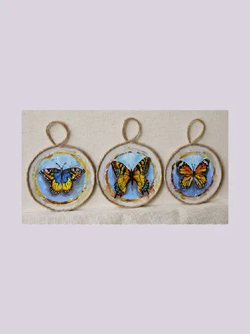 Butterfly medallions painted with oil paints on quartz vinyl, with a loop to hang. 3 pieces. $85.00