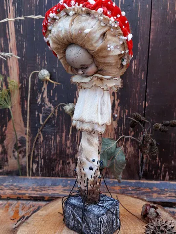 Art doll Mushroom. Unusual handmade statuette. Sleeping child-toy in the image of a fly mushroom. Mushroom is a textile sculpture. Unique statuette made of fabric and polymer clay, decorated with beads and beads. An art object for your interior and collec